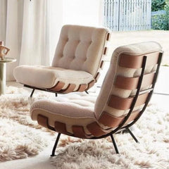 Modern lounge chair with beige cushion and leather strap back