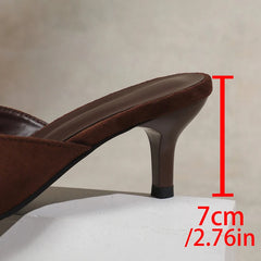Brown high-heeled shoe with a measurement label indicating heel height on a neutral background