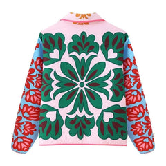Back view of a quilted jacket showcasing a large central floral motif.