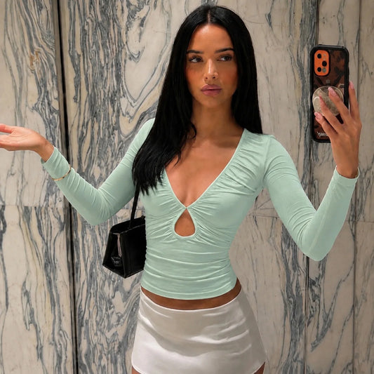 Mint green ruched cutout long sleeve crop top on model