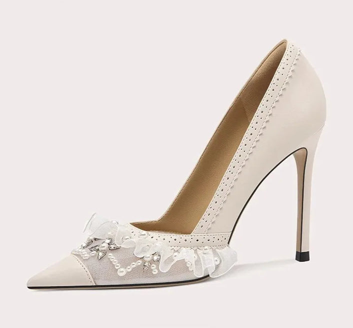 High-heeled shoe with lace details on a light gray background