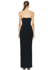 A model wearing a stunning black diamond spaghetti strap maxi dress with a backless design.