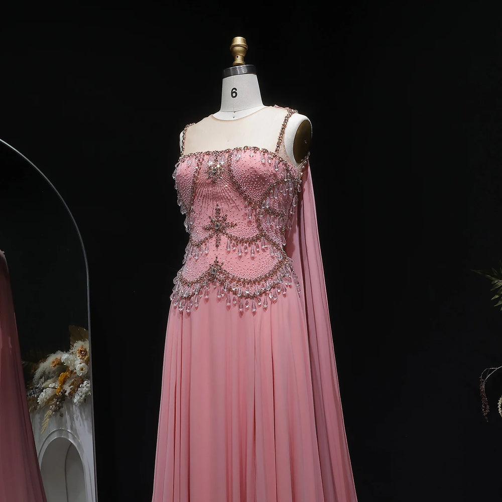 Pink evening gown with intricate beading on a mannequin against a black background