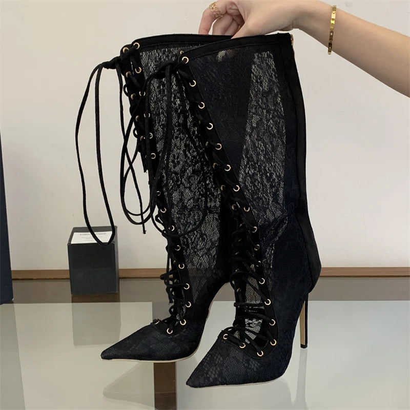 Hand holding lace-up knee-high boot