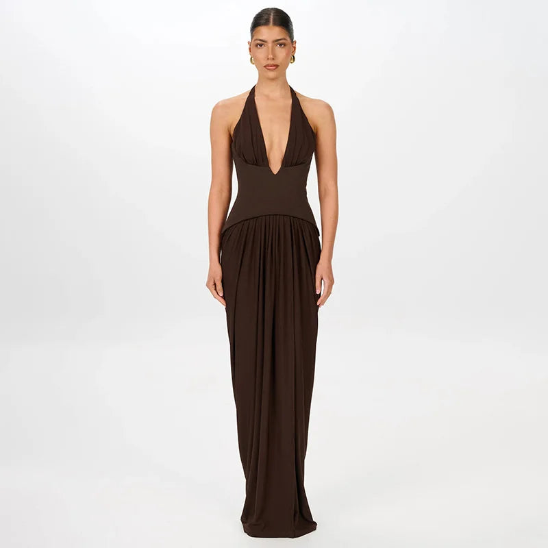 Woman wearing a brown halter neck gown on a white background