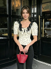 Full view of polka dot peplum top on model