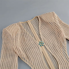Close-up of crystal embellishment on knit dress neckline