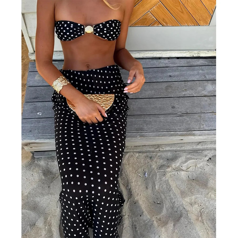 Close up of polka dot bikini and maxi skirt with accessories