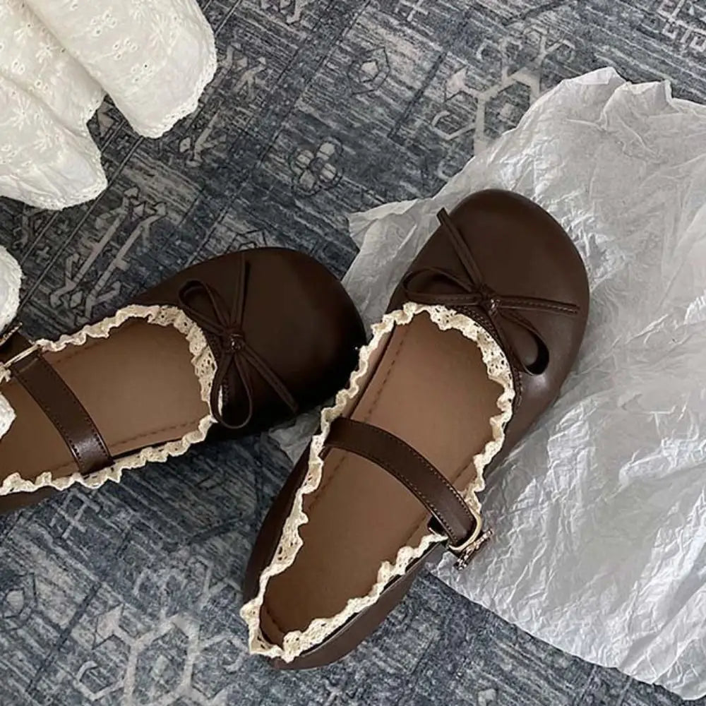 Close-up of brown lace ruffled bow Mary Jane flats