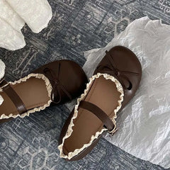 Close-up of brown lace ruffled bow Mary Jane flats