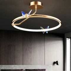 Modern ceiling light fixture with butterfly decorations in a room setting.