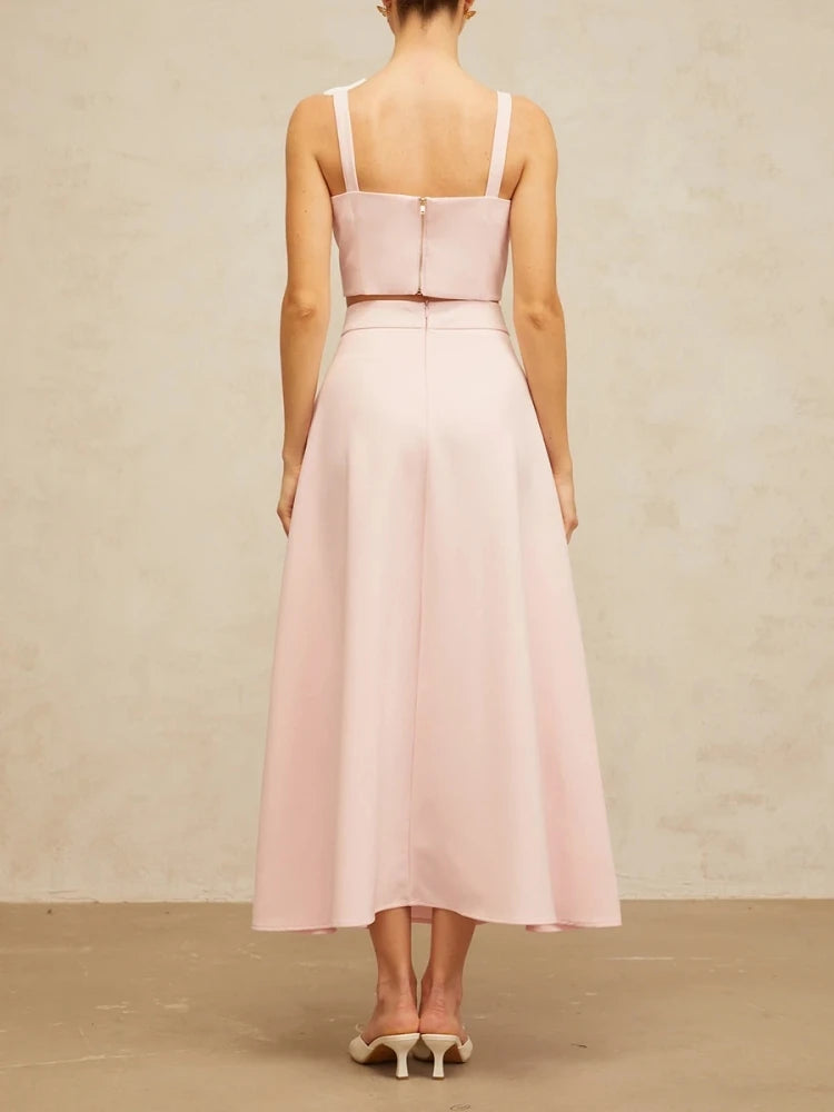 Pink dress with thin straps on a plain background