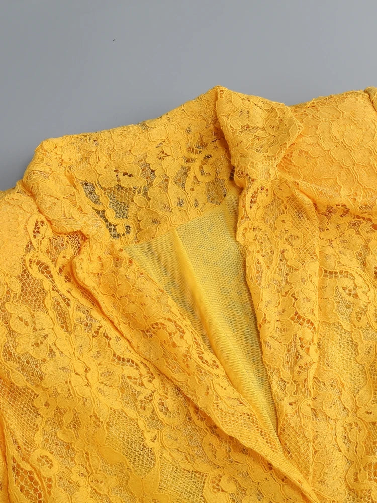Close-up of yellow lace fabric on a gray background