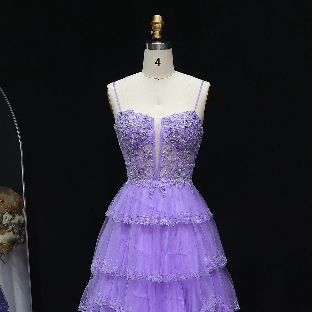 Purple lace dress on a mannequin against a black background
