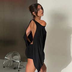 Model wearing a black open back long sleeve midi dress
