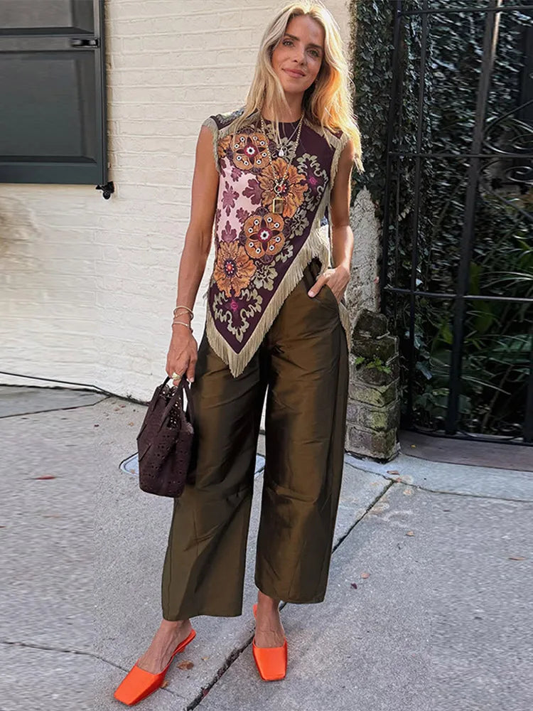 Boho patchwork sleeveless vest with fringe and floral print worn by a model