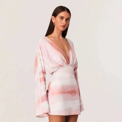 Close-up of a pink tie-dye long sleeve deep v-neck mini dress