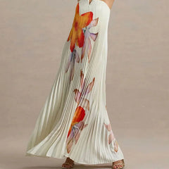 Long white dress with colorful floral pattern on a neutral background