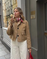 A model wearing a stylish brown cropped suede jacket, showcasing its fit and design. Golden Atelier 3