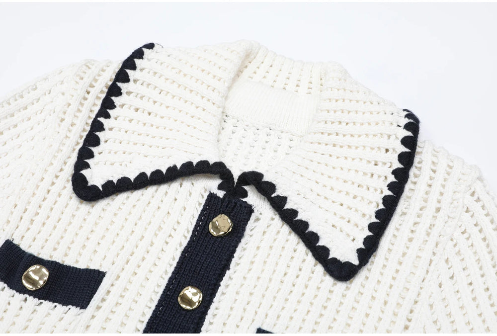 Close-up of the white knit collar with black scalloped trim