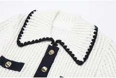 Close-up of the white knit collar with black scalloped trim