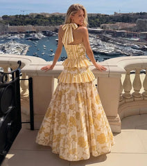 Yellow patterned halter neck top and tiered skirt swimwear set, back view