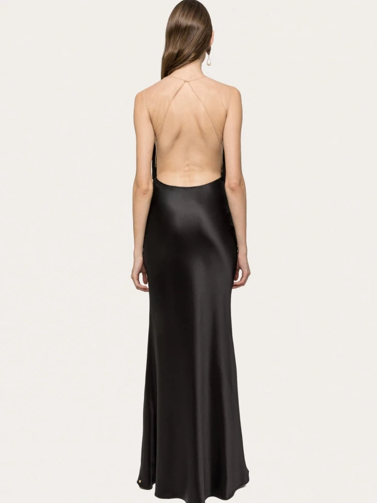Black satin halter neck gown on a white background