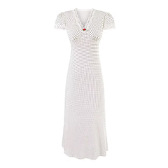 White dress with black polka dot pattern on a white background