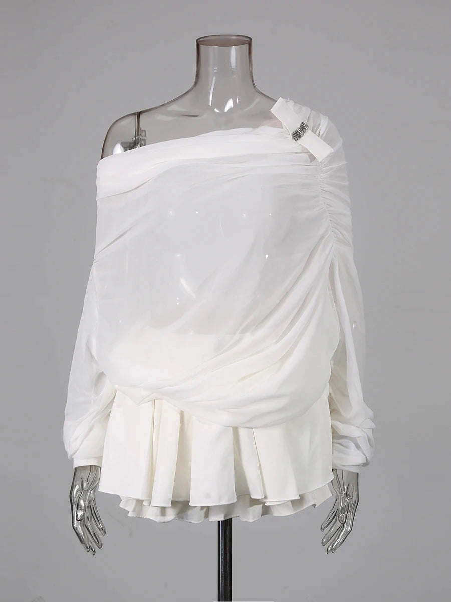 White draped garment on a mannequin against a gray background