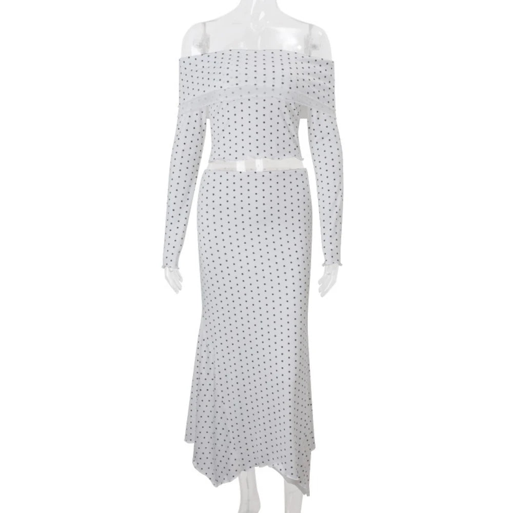 White off-shoulder dress with black polka dot pattern on a white background