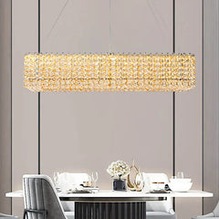 A stunning champagne crystal bead chandelier illuminating a modern dining room.  Golden Atelier 3