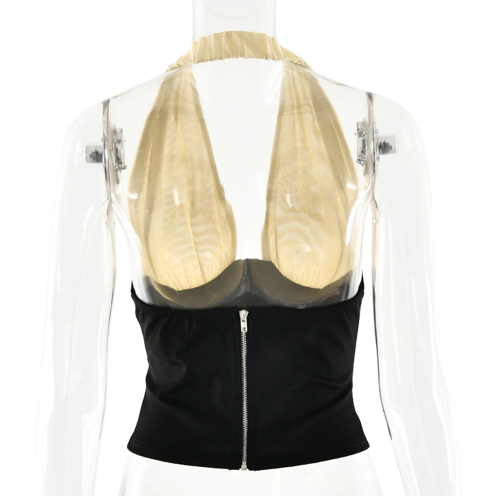 Black top with a sheer beige bralette on a mannequin against a white background