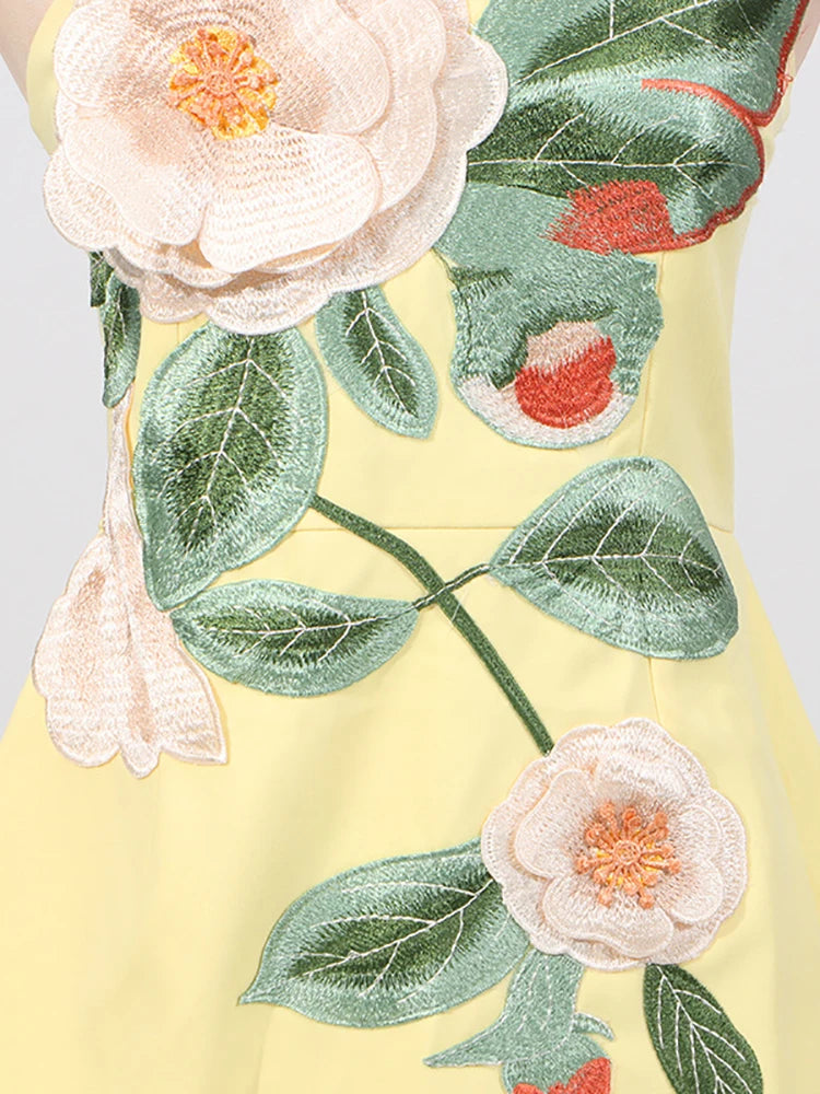 Close-up of a yellow fabric with floral embroidery