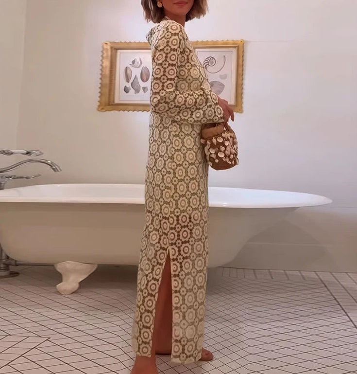Woman in a patterned dress standing in a bathroom with a bathtub and framed picture on the wall.
