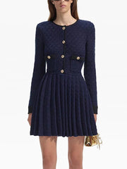 Navy blue dress with gold buttons worn by a model on a white background