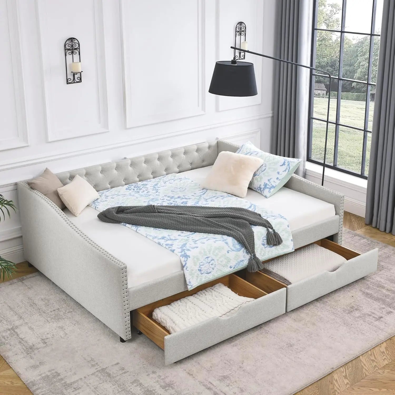Gray upholstered bed with storage drawers in a bedroom setting