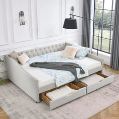 Gray upholstered bed with storage drawers in a bedroom setting