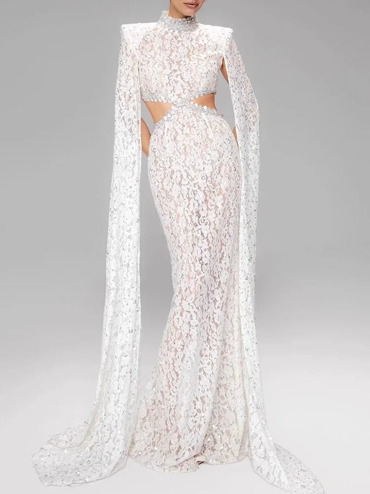 White lace evening gown with long cape on a gray background