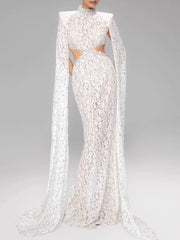 White lace evening gown with long cape on a gray background