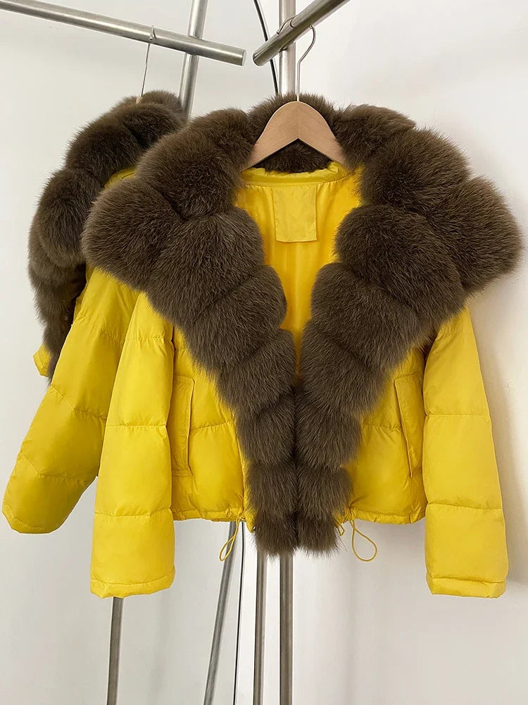 Yellow puffer jacket with brown fur collar on a hanger against a white background