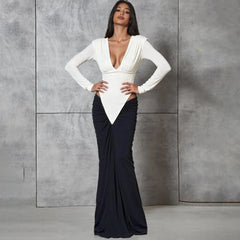 Woman wearing a white top and black skirt against a gray background