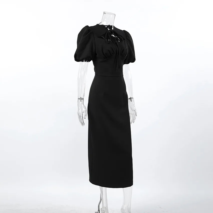 Black dress on a mannequin against a white background