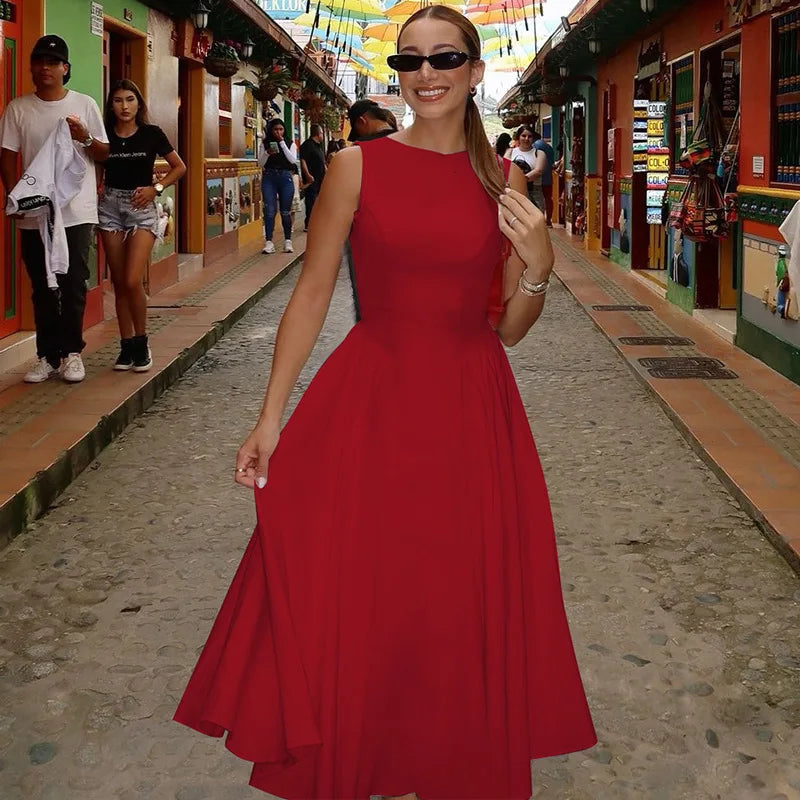 Woman in a red dress standing on a street with colorful buildings in the background
