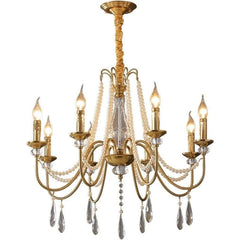 Gold chandelier with crystal accents on a white background