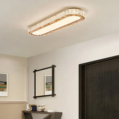 Modern ceiling light fixture in a room with a mirror and artwork on the wall.