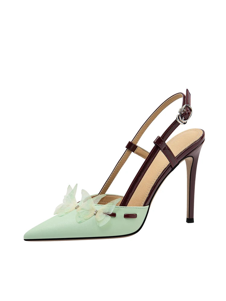 Mint green high-heeled shoe with a brown strap on a white background