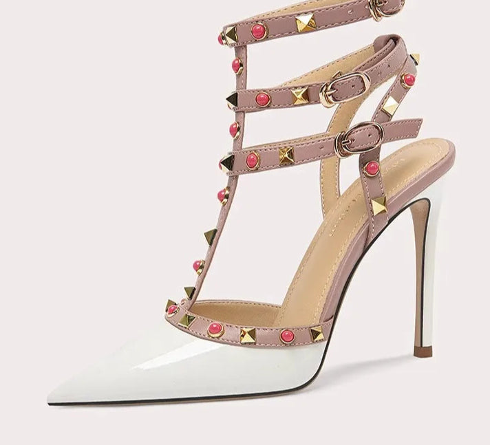 High-heeled shoe with studded design on a white background