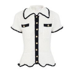 White knit collared short sleeve top with black trim and gold buttons