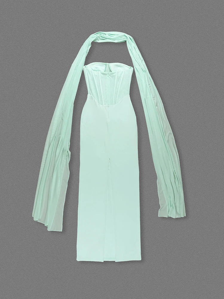 Mint green dress with sheer sleeves on a gray background