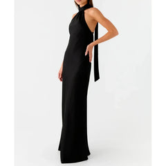 Black halter neck gown with a long train on a white background